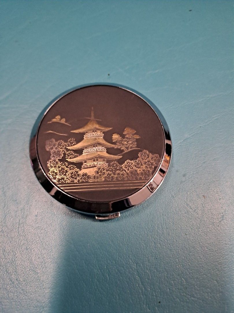 Elegance Powder Compact with Floral Design (Category: Makeup) located in Manila. Submitted by joanbalde39643 (Listing ID 1423531842, Image 1). Description: Elegant powder compact with a beautiful floral design on the lid. The compact includes a mirror and a powder compartment with a powder puff. The brand name "Elegance" is visible on the powder. The compact has a silver-colored frame. It is a round shape..