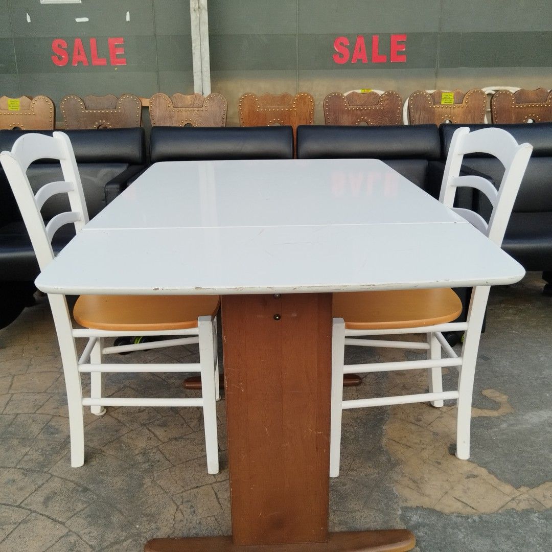 Extendable Dining Table with 2 Chairs (Category: Tables & Sets) located in Paranaque City. Submitted by eu.kr.jpsurplus (Listing ID 1423556458, Image 2). Description: Dining set includes an extendable white table and two chairs. The table has a brown wooden base. The chairs have white frames and tan seats. The table is extendable, offering flexibility for different dining needs. Perfect for small spaces or gatherings..