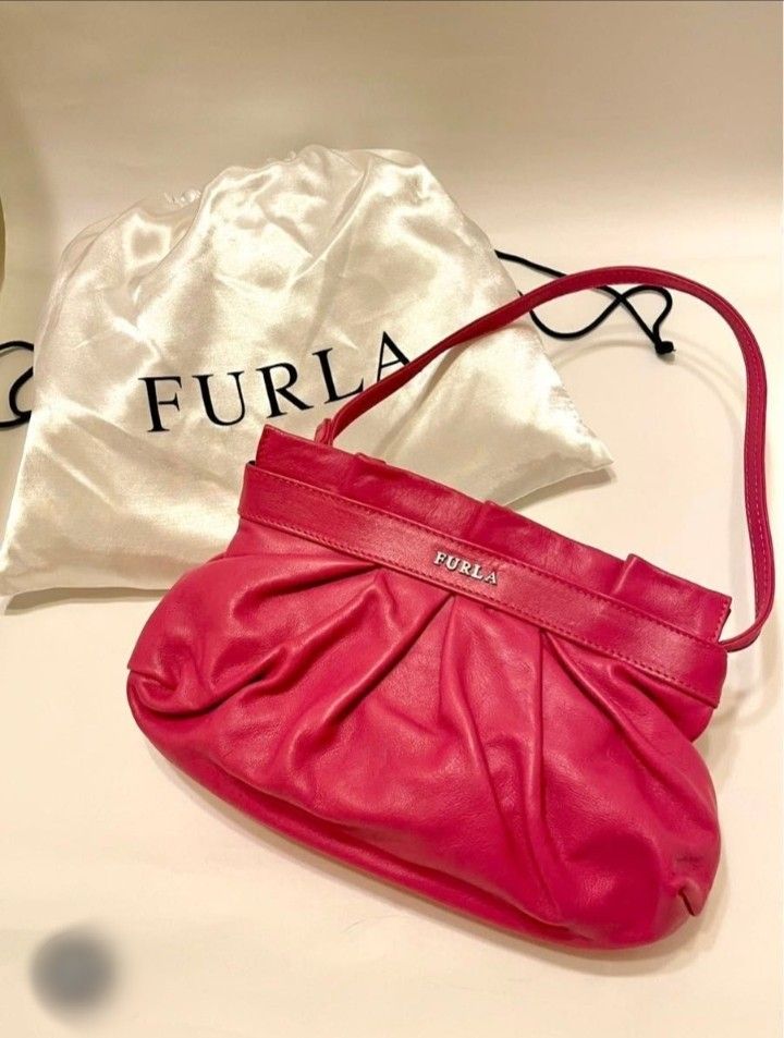 Furla Pink Leather Shoulder Bag (Category: Luxury Bags & Wallets) located in Manila. Submitted by alayassulittipidfinds (Listing ID 1423545467, Image 1). Description: Furla shoulder bag is a vibrant pink color. It features a gathered design and a top handle. The bag includes a matching dust bag. The interior has a polka dot lining. The Furla logo is visible on the front of the bag..