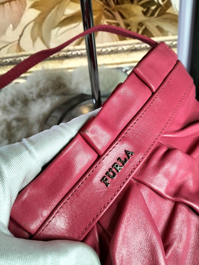 Furla Pink Leather Shoulder Bag (Category: Luxury Bags & Wallets) located in Manila. Submitted by alayassulittipidfinds (Listing ID 1423545467, Image 3). Description: Furla shoulder bag is a vibrant pink color. It features a gathered design and a top handle. The bag includes a matching dust bag. The interior has a polka dot lining. The Furla logo is visible on the front of the bag..