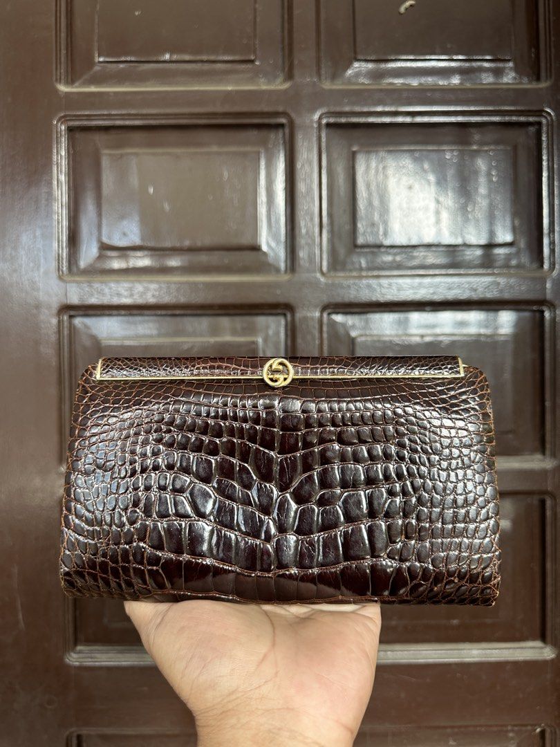 Gucci alligator evening Clutch (Category: Luxury Bags & Wallets) located in Bustos. Submitted by theprelovedshopbulacan (Listing ID 1423438428, Image 1). Description: - Vintage Gucci clutch bag - Brown crocodile leather - Gold-tone GG logo clasp - Rectangular shape - Structured design - Similar bag retails for $1,525.