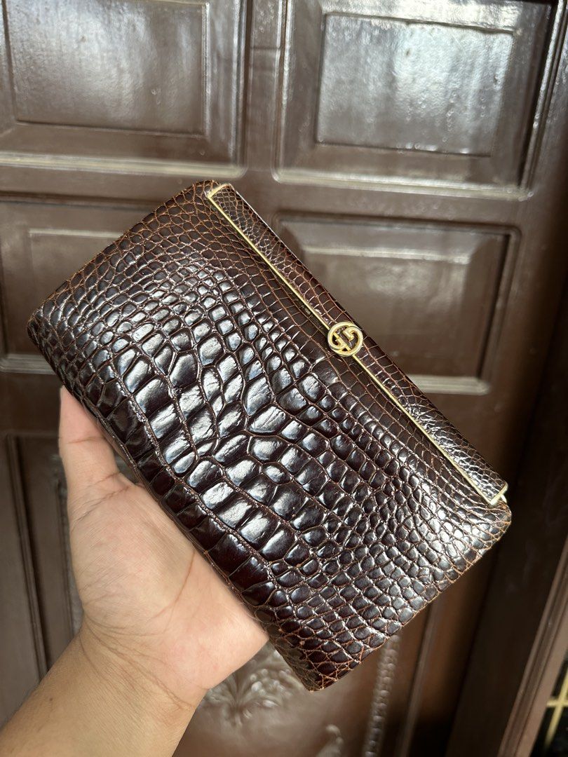 Gucci alligator evening Clutch (Category: Luxury Bags & Wallets) located in Bustos. Submitted by theprelovedshopbulacan (Listing ID 1423438428, Image 2). Description: - Vintage Gucci clutch bag - Brown crocodile leather - Gold-tone GG logo clasp - Rectangular shape - Structured design - Similar bag retails for $1,525.