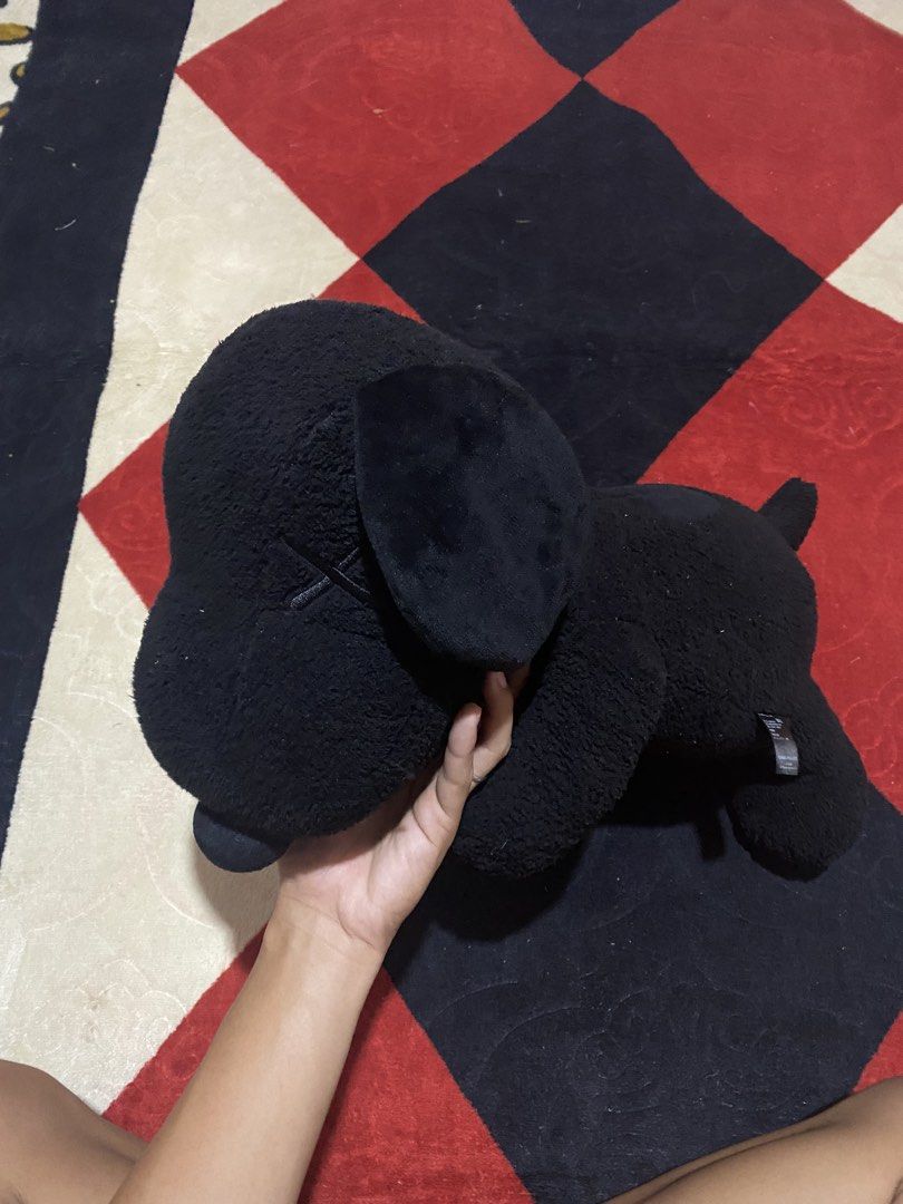 KAWS x Peanuts Snoopy Plush Toy (Category: Plushies & Soft Toys) located in Opol. Submitted by yashaofficial (Listing ID 1423476578, Image 1). Description: - KAWS x Peanuts Snoopy plush toy - Color: Black - Design: KAWS "XX" on one eye - Collaboration: Uniqlo - Pose: Snoopy lying down - Material: 100% Polyester.
