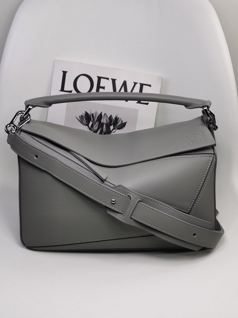 Loewe Puzzle Bag - Grey (Category: Luxury Bags & Wallets) located in Quezon City. Submitted by herluxe_official (Listing ID 1423505494, Image 1). Description: Loewe Medium Puzzle Bag Bought from Hongkong. Dimensions: Medium: (28/29 x 19 x 14 cm) ✈️WE SHIP NATIONWIDE ✅SAME DAY DISPATCH Complete inclusions Dustbag, paperbag, cards and box .