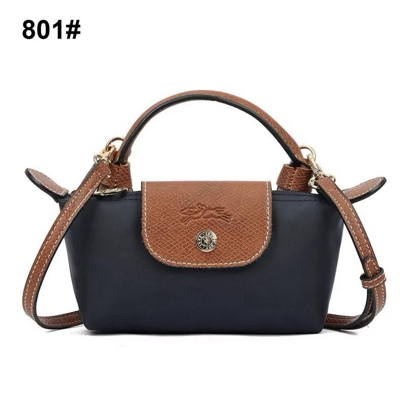 Longchamp Le Pliage Cuir Crossbody Bag (Category: Luxury Bags & Wallets) located in Zamboanga. Submitted by smartstyle (Listing ID 1423464708, Image 1). Description: - Authentic Longchamp Le Pliage Cuir crossbody bag - Color: Navy blue body with brown leather flap and handles - Detachable shoulder strap - Top handle - Gold-toned hardware - Snap closure with Longchamp logo.