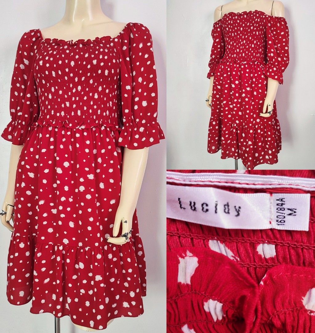 Lucidy Red Polka Dot Dress (Category: Dresses) located in Malolos. Submitted by missythreadsph (Listing ID 1423541059, Image 1). Description: Dress features a vibrant red color with white polka dots. It has an off-shoulder design with short sleeves and a ruffled hem. The dress is made by Lucidy and is size M (160/84A). It has a smocked bodice and a flowy skirt. Perfect for a casual day out or a summer gathering..