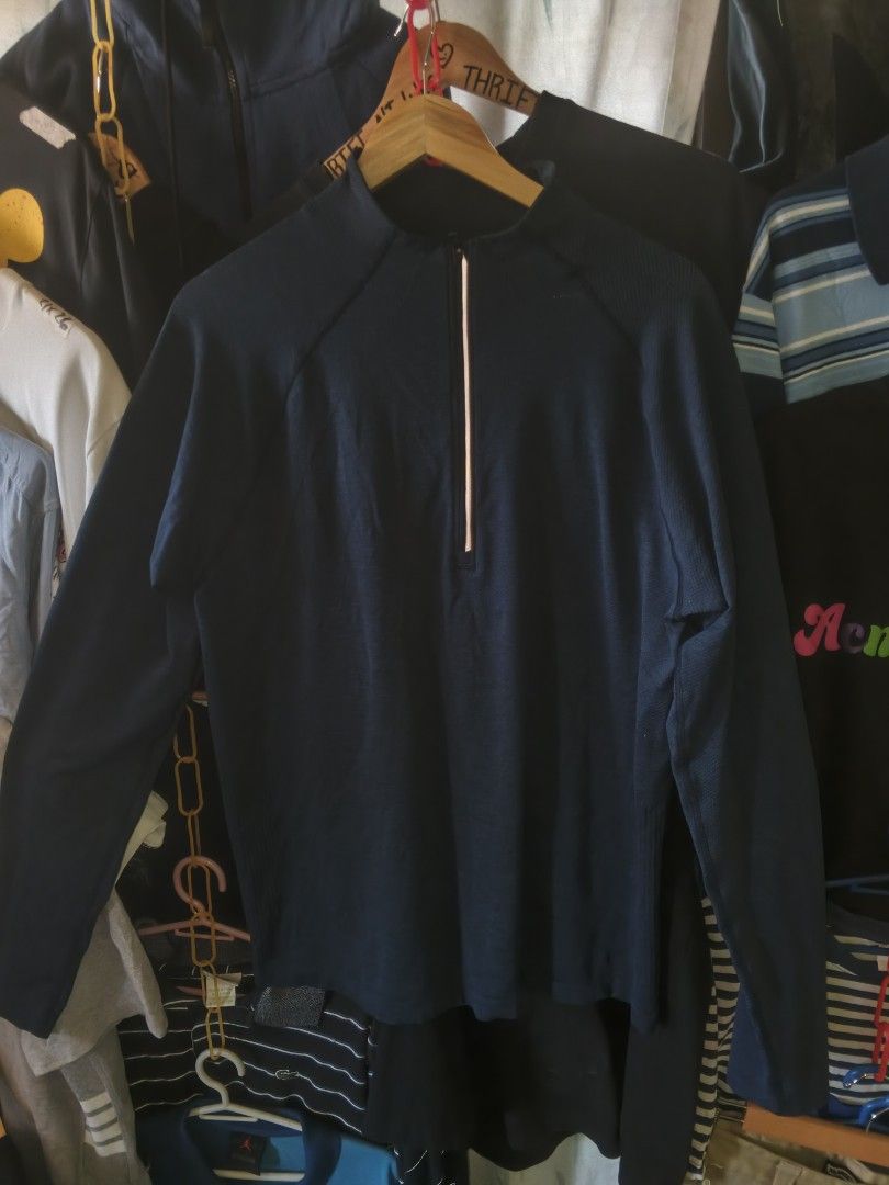 Lululemon Long Sleeve Top (Category: Activewear) located in Manila. Submitted by wesleycomad21 (Listing ID 1423473523, Image 1). Description: - Navy blue long sleeve top - Half-zip closure - Small logo on left sleeve - Mock neck design - Made of performance fabric - Reflective strip on zipper Dimes 21by28.