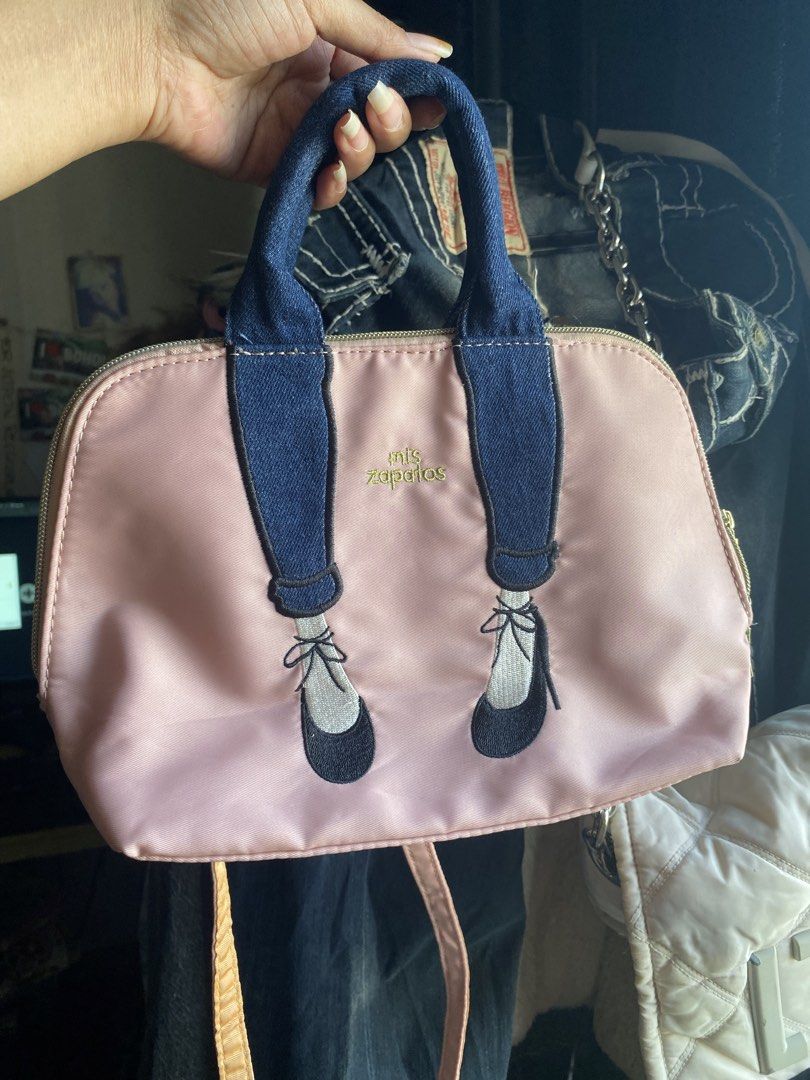 Mis Zapatos Pink Handbag (Category: Tote Bags) located in Mandaue City. Submitted by lizcui28 (Listing ID 1423513275, Image 1). Description: - Pink handbag with a unique design - Denim handles - Shoe-themed graphic - Secure zip closure - Detachable shoulder strap - Interior with multiple compartments - Elegant gold-toned hardware - Brand name detail on zipper.