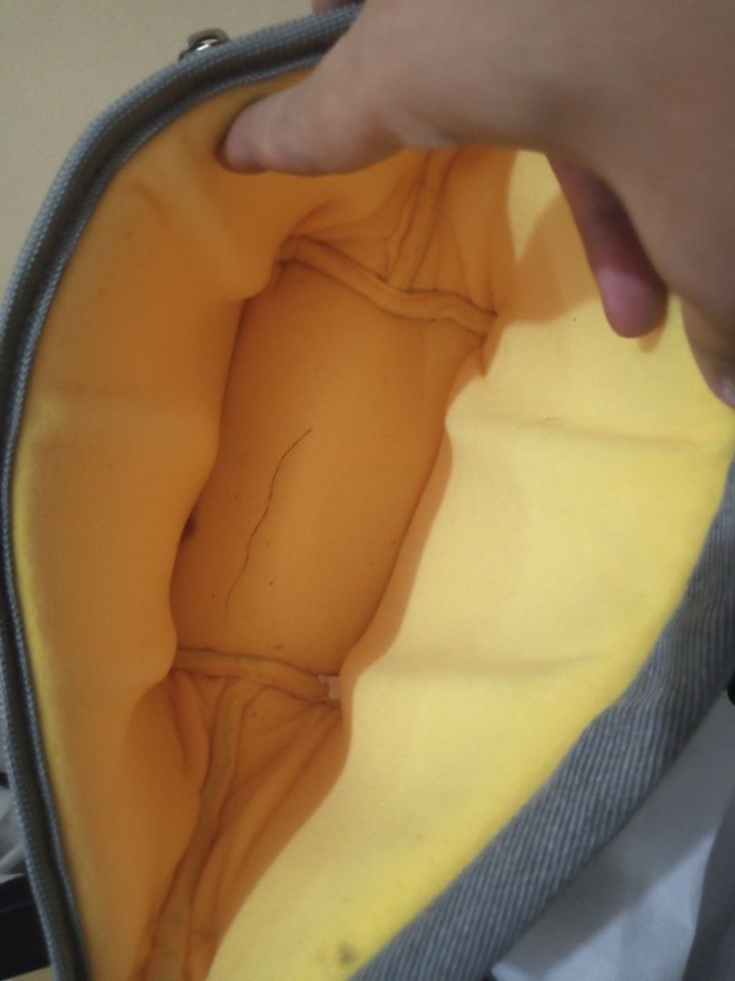 Nikon Camera Bag (Category: Camera Bags & Carriers) located in Taguig. Submitted by wkbrandedpreloved (Listing ID 1423437817, Image 2). Description: - Gray Nikon camera bag - Black strap - Zippered side pocket - Yellow interior lining - Flap closure with black buckle - Nikon logo on front.