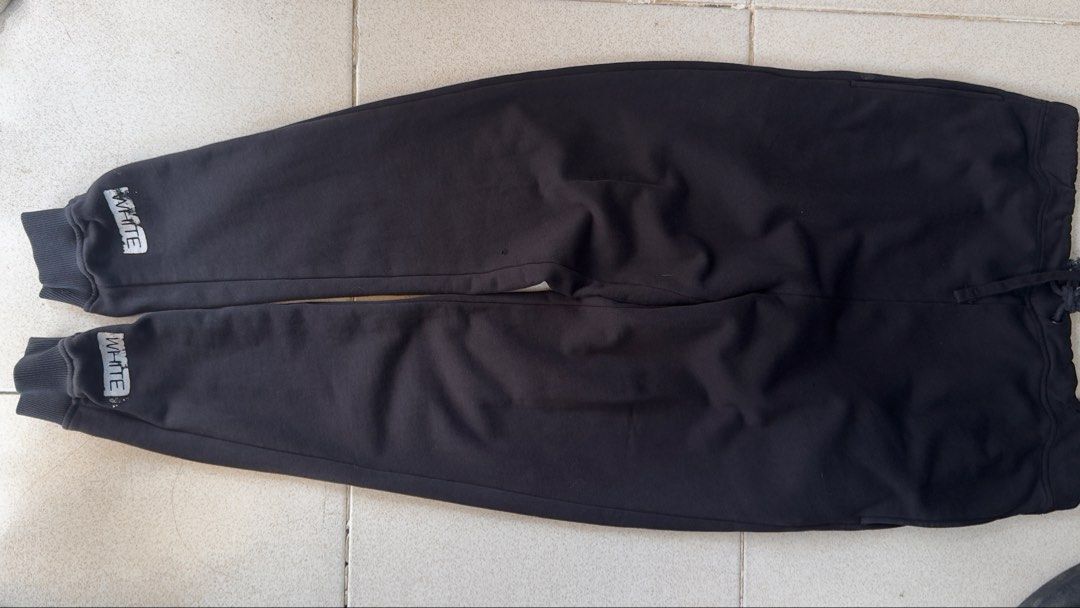 Off-White Black Sweatpants (Category: Joggers) located in Padre Garcia. Submitted by dripden_ph (Listing ID 1423468813, Image 1). Description: - Off-White sweatpants - White stripes on legs - "WHITE" printed on cuffs - Drawstring waist - Soft, comfortable material - Size tag visible - Perfect for casual wear -34x42.