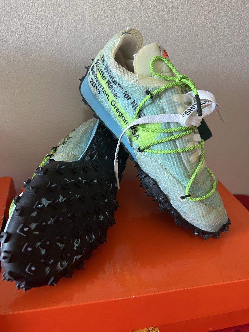 Off-White x Nike Waffle Racer Sneakers (Category: Sneakers) located in Manila. Submitted by murafinds26 (Listing ID 1423577472, Image 2). Description: Off-White x Nike Waffle Racer sneakers. Features a unique design with text details and spiked soles. Comes with original box and extra laces. One pair has a green and white color scheme, while the other has a pink and black color scheme. The shoes have the "SHOELACES" tag..