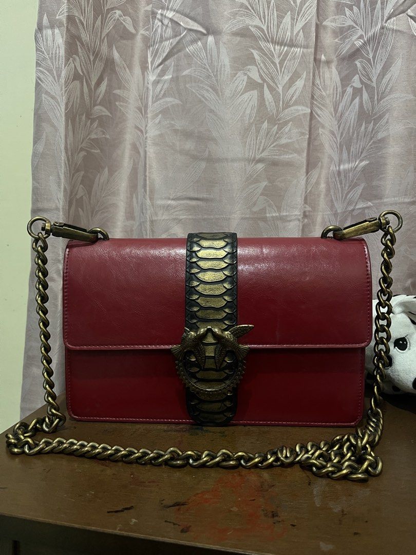 Pinko Love Bag (Category: Luxury Bags & Wallets) located in Las Pinas. Submitted by preloved_koto (Listing ID 1423557512, Image 2). Description: - Pinko Love Bag - Chain strap - Unique snake clasp design - Rectangular shape - Flap closure - Gold-colored chain - Made of leather.
