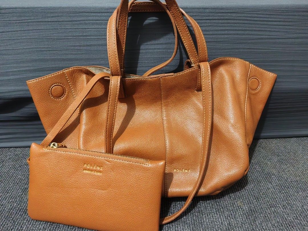 Polene Handbag with Pouch (Category: Luxury Bags & Wallets) located in San Pedro. Submitted by charlie0603 (Listing ID 1423564103, Image 1). Description: Polene handbag in a warm brown color. It includes a matching pouch. The bag has two handles and a shoulder strap. The design features a simple, elegant aesthetic..