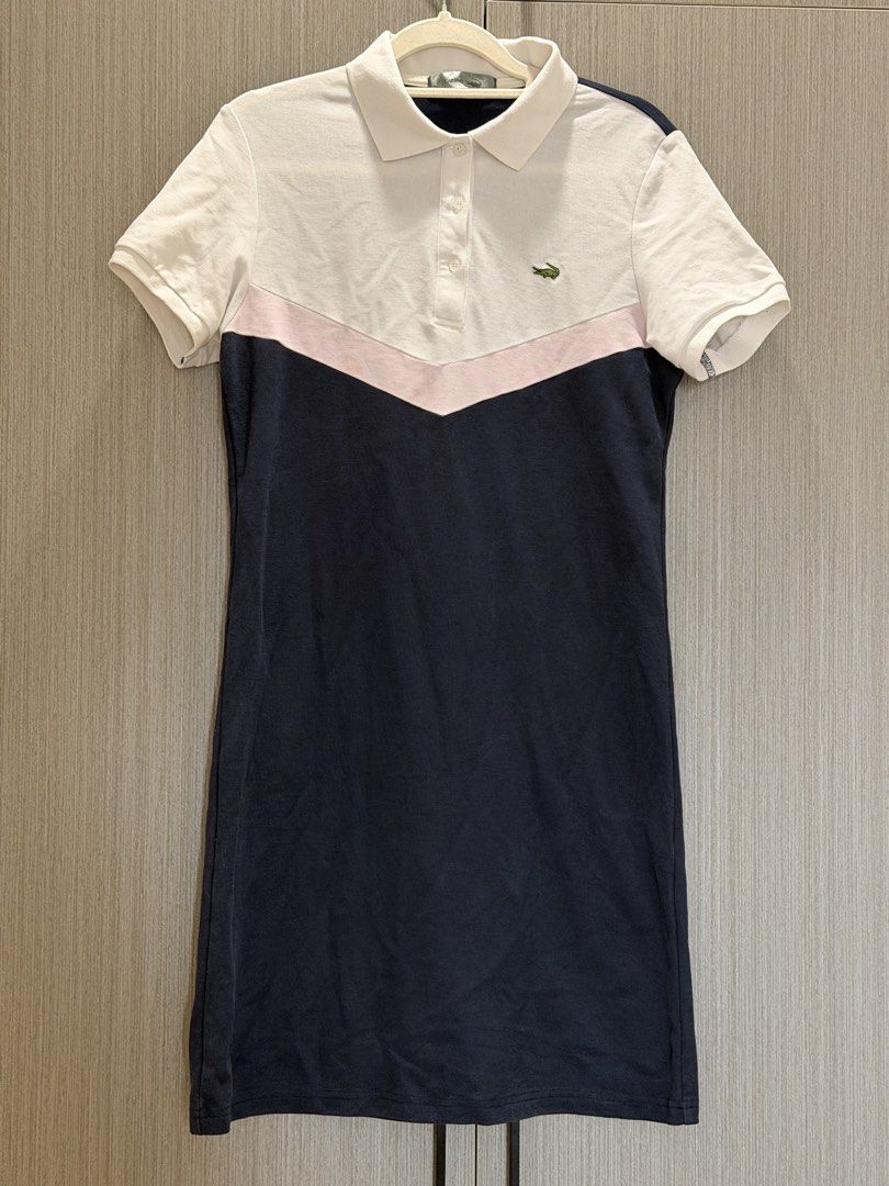 Polo Dress (Category: Dresses) located in Pasay City. Submitted by wuangel_ (Listing ID 1423472756, Image 2). Description: - Lacoste polo dress - Classic design - White collar and sleeves - Pink chevron detail - Navy blue body - Short-sleeved - Button-up front - Lacoste logo on chest - Comfortable fabric.