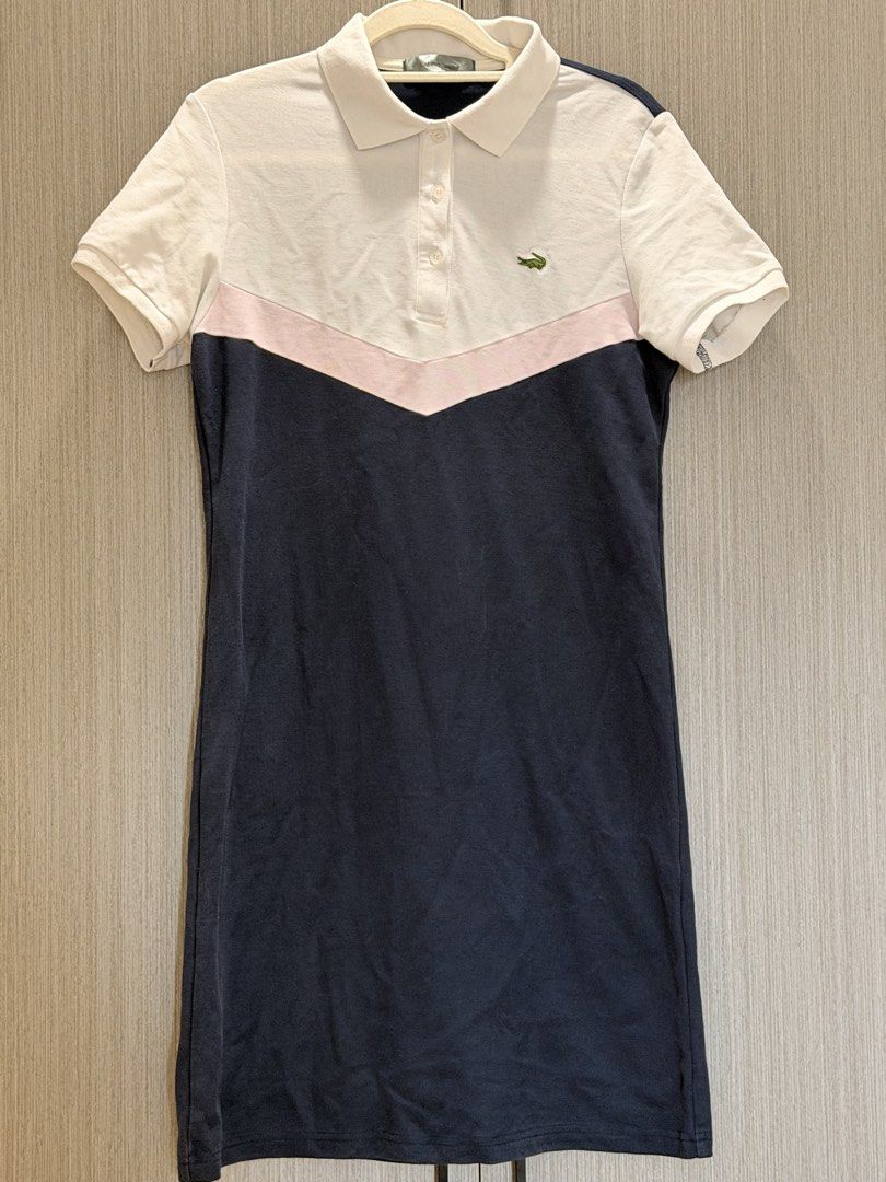 Polo Dress (Category: Dresses) located in Pasay City. Submitted by wuangel_ (Listing ID 1423472756, Image 3). Description: - Lacoste polo dress - Classic design - White collar and sleeves - Pink chevron detail - Navy blue body - Short-sleeved - Button-up front - Lacoste logo on chest - Comfortable fabric.