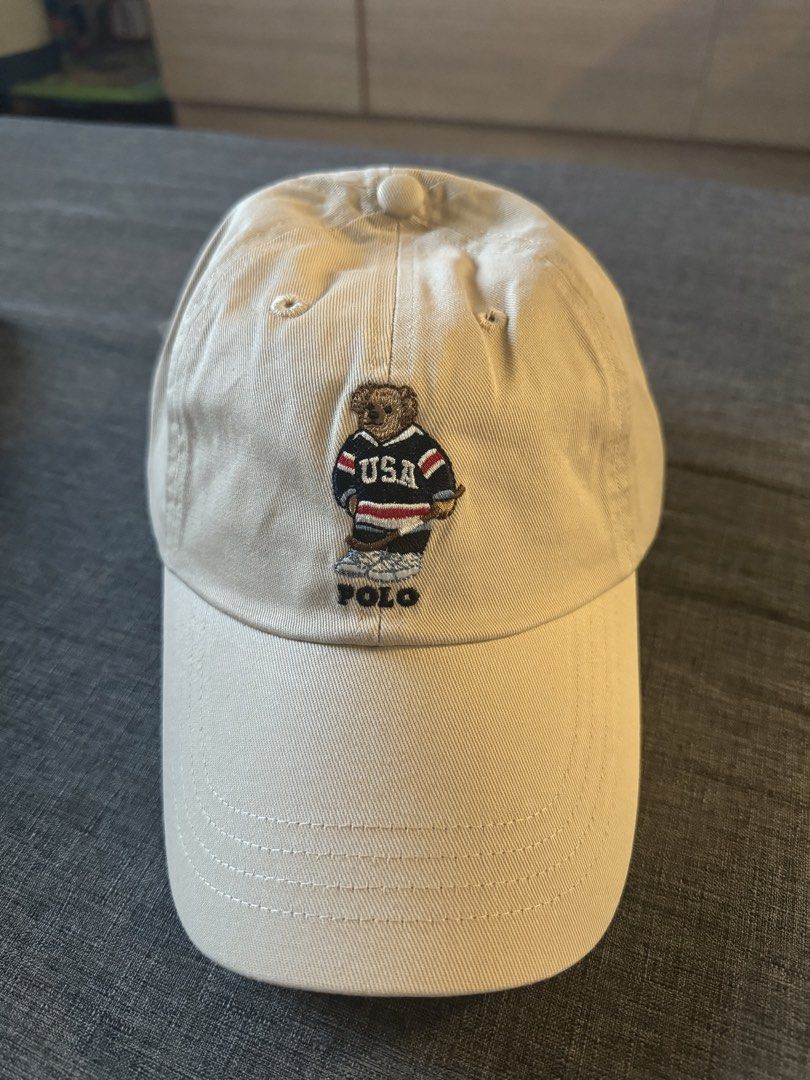 Polo Ralph Lauren Bear Cap (Category: Caps & Hats) located in San Juan City. Submitted by rlcaps (Listing ID 1423529097, Image 1). Description: - Polo Ralph Lauren Bear Cap - Beige color - Features the iconic Polo bear wearing a USA hockey jersey - Embroidered Polo logo - Curved brim - Adjustable strap at the back - Made of durable cotton material.