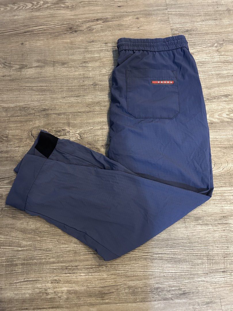 Prada - NYLON TRACKPANTS (Category: Joggers) located in Los Banos. Submitted by londunplaya (Listing ID 1423448310, Image 1). Description: MEASUREMENTS: WAIST: 33-38 THIGH: 11 IN. KNEE: 10 IN. INSEAM: 26.5 IN. FRONT RISE: 13 IN. LEG OP: 5.5 IN. NO MAIN TAG, FADED WASHTAG.