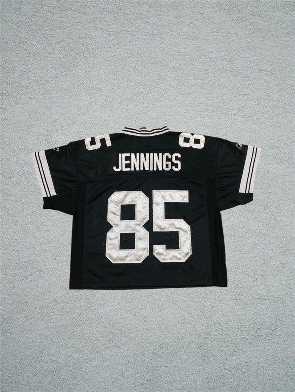 Reebok NFL Jersey - 85 Jennings (Category: Activewear) located in Mandaluyong City. Submitted by yesyesbuybuy (Listing ID 1423578982, Image 2). Description: Black Reebok NFL jersey. Features the number 85 on the front and back. The name "Jennings" is printed on the back above the number. Includes white stripes on the sleeves and collar. The jersey has a V-neck design. 23x25 Good for street wear fits! .