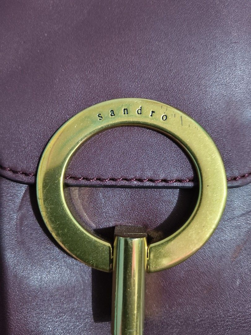 Sandro Leather Crossbody Bag (Category: Luxury Bags & Wallets) located in Mandaue City. Submitted by prekfinds (Listing ID 1423528591, Image 2). Description: SANDRO pepita deep red MaroonLeather Cross-body bag /shoulder bag Excellentcondition 10/10colorate Dimes:9inchesW by 8inches L Very stylish and sophisticated Features Gold plated hardware Adjustable sling belt Clean inside and out very miniamal scracth only no major flaws .