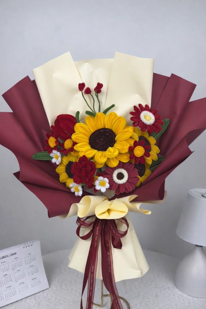 Sunflower Bouquet (Category: Flowers & Bouquets) located in Las Pinas. Submitted by thrifty_style (Listing ID 1423547021, Image 2). Description: Beautiful handmade sunflower bouquet. Features vibrant yellow sunflowers and other colorful crochet flowers. Wrapped in elegant paper with ribbon accents. Perfect for gifting or as a decorative piece. Available in two color schemes: blue and yellow, or red and yellow. A unique and charming floral arrange