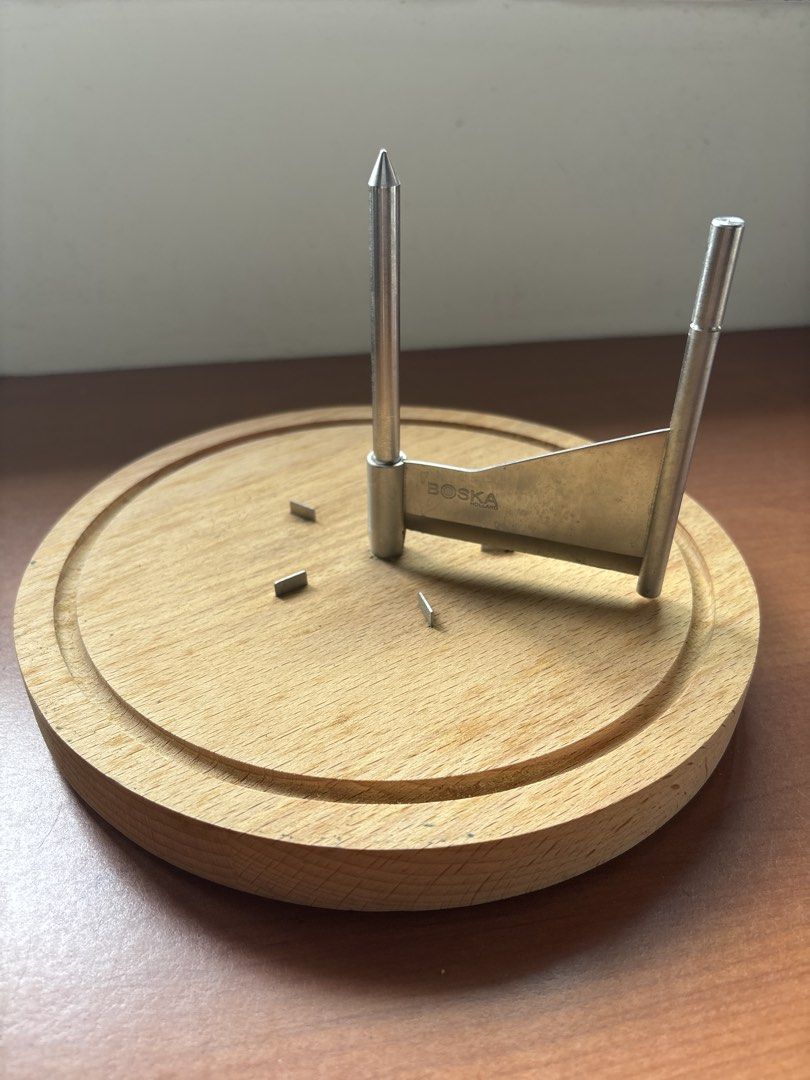 Tete de moine cheeseboard (Category: Knives & Chopping Boards) located in Singapore. Submitted by bompow (Listing ID 1423535639, Image 1). Description: A cheeseboard fitted for a block of tete de moine cheese. The blade attached to the spine. When rotated, it scrapes the surface of the cheese. The end result is a beautiful piece of flower cheese..