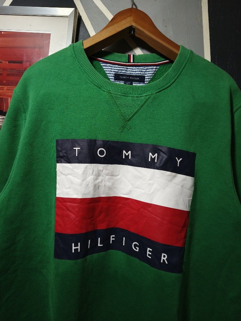 Tommy Hilfiger Green Sweatshirt (Category: Coats, Jackets and Outerwear) located in Manila. Submitted by purefire-477a (Listing ID 1423574632, Image 3). Description: Green Tommy Hilfiger sweatshirt with the brand's logo on the front. Features a crew neck and long sleeves. The tag indicates a size L. The color is vibrant green..