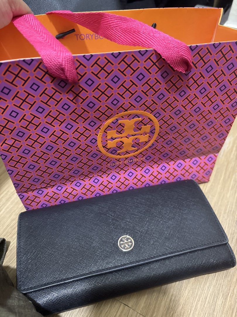 Tory Burch Black Wallet (Category: Luxury Bags & Wallets) located in Pasig City. Submitted by dyclutterwithme (Listing ID 1423576906, Image 1). Description: Preloved Tory Burch black wallet. Features card slots, zippered compartment, and snap closure. Includes original shopping bag. 🌸 Note ‼️ Please check latter photos for signs of peeling on the sides. Not obvious naman and I think you can cut them out na lang or glue them back if ever. RFS: De
