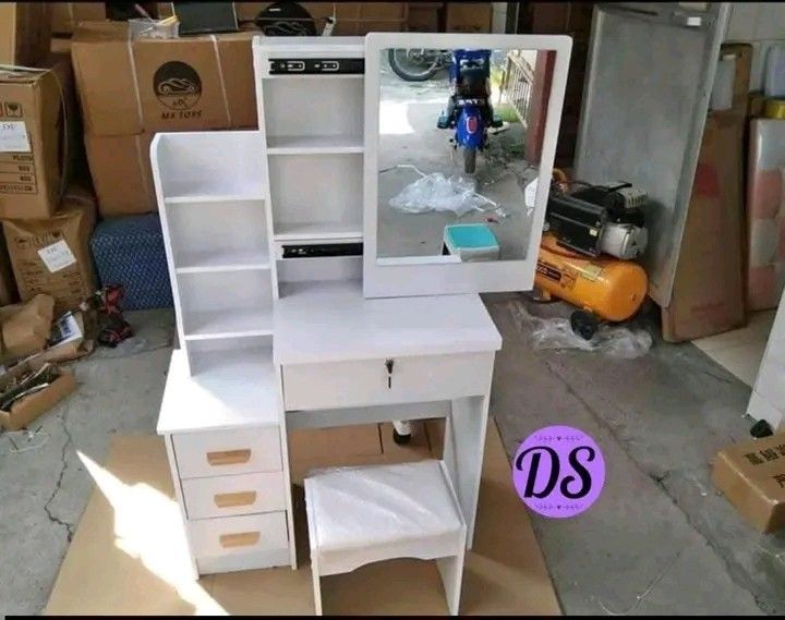 Vanity Table with Mirror (Category: Tables & Sets) located in Manila. Submitted by micoooy (Listing ID 1423533647, Image 3). Description: - Vanity table set includes mirror, table with drawer, and stool. - Features a side cabinet with shelves and drawers for storage. - Available colors: Pink, White, Brown. - Perfect for organizing makeup and accessories. - Compact design, suitable for bedrooms and dressing areas..