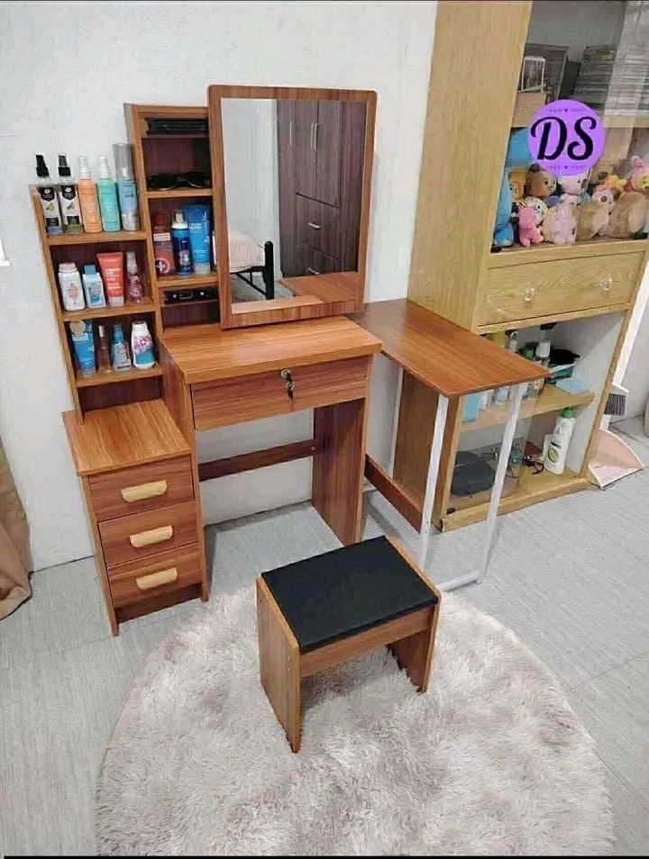 Vanity Table with Mirror (Category: Tables & Sets) located in Manila. Submitted by micoooy (Listing ID 1423533647, Image 2). Description: - Vanity table set includes mirror, table with drawer, and stool. - Features a side cabinet with shelves and drawers for storage. - Available colors: Pink, White, Brown. - Perfect for organizing makeup and accessories. - Compact design, suitable for bedrooms and dressing areas..