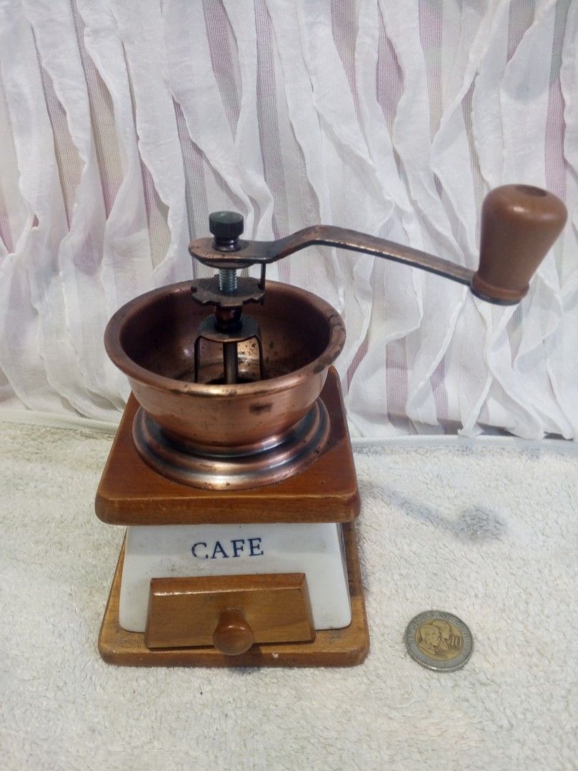 Vintage coffee grinder (Category: Coffee & Tea Tableware) located in Makati City. Submitted by nherlhez_24 (Listing ID 1423448506, Image 1). Description: vintage coffee grinder made of metal,wood,and ceramic material ..