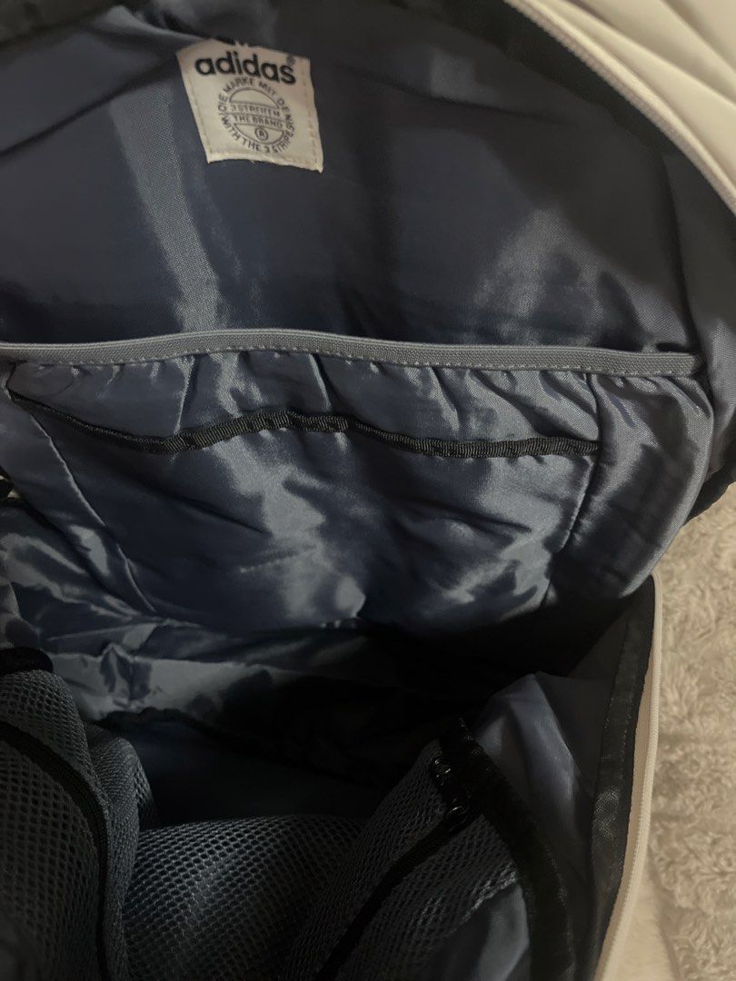 Adidas Backpack (Category: Backpacks) located in Pasig City. Submitted by jundbaptist21 (Listing ID 1423685870, Image 3). Description: - Adidas backpack in a light color - Main compartment for storage - Front pocket for easy access - Side pockets for water bottles or small items - Dark blue interior lining - Adidas logo on the front - Iconic three stripes on the back - Brand new with tags -FROM U.S.