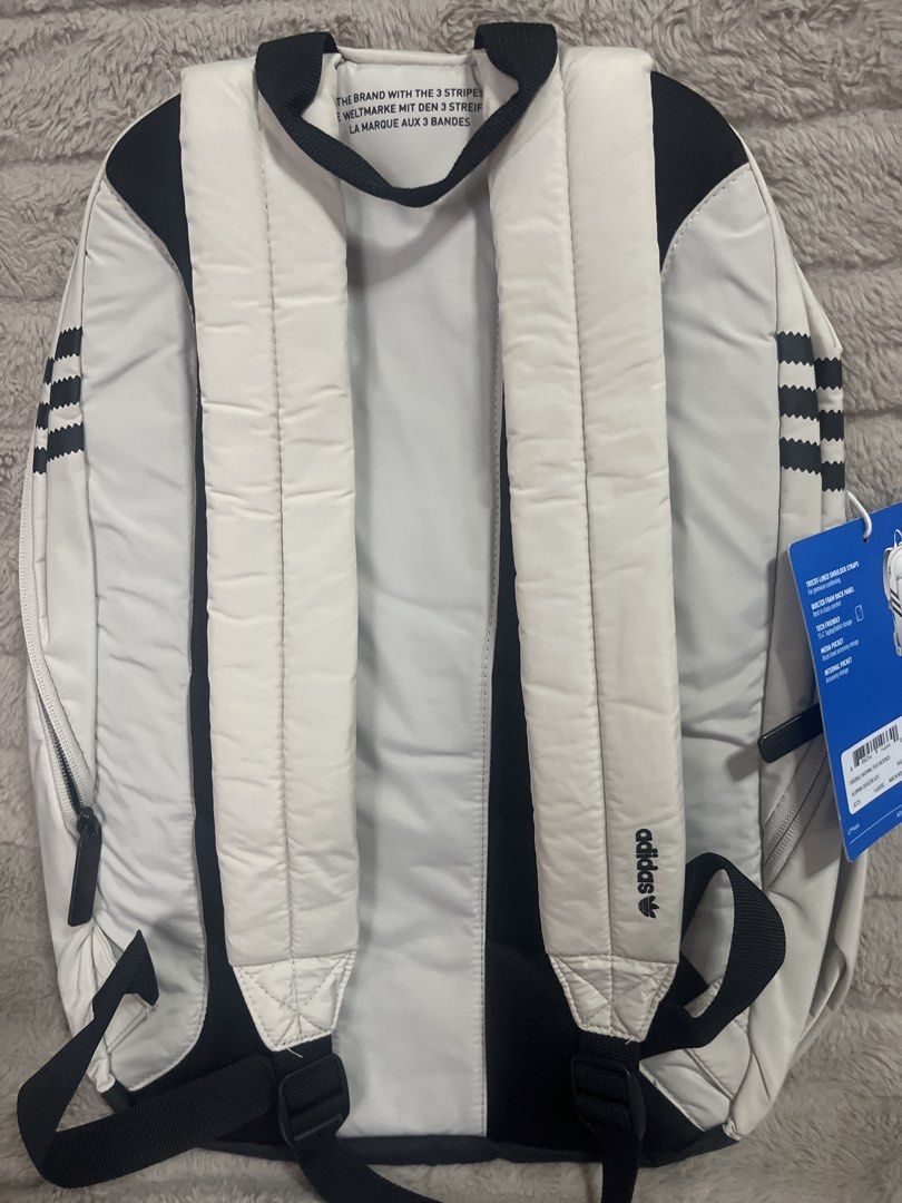 Adidas Backpack (Category: Backpacks) located in Pasig City. Submitted by jundbaptist21 (Listing ID 1423685870, Image 2). Description: - Adidas backpack in a light color - Main compartment for storage - Front pocket for easy access - Side pockets for water bottles or small items - Dark blue interior lining - Adidas logo on the front - Iconic three stripes on the back - Brand new with tags -FROM U.S.