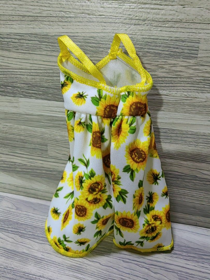 Barbie Sunflower Print Dress (Category: Dresses) located in Quezon City. Submitted by silverturtle_32df92 (Listing ID 1423634669, Image 2). Description: Original Mattel Barbie dress not played with, like new non ag no box actual photos what you see is what you get MOP: GCASH, BPI MOD: J&T Express, Lalamove Location: Novaliches, Quezon City.