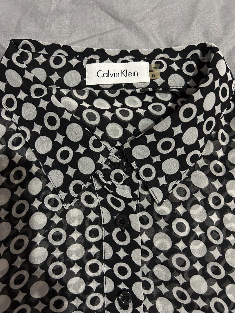 Calvin Klein Sleeveless Dress (Category: Dresses) located in Cavite. Submitted by beeminees (Listing ID 1423623323, Image 2). Description: - Calvin Klein sleeveless dress - Size 6 - Sheer fabric - Black and white geometric pattern - Collared neckline - Button-down front - Length: Approximately 38 inches - Waist: Approximately 15 inches across.