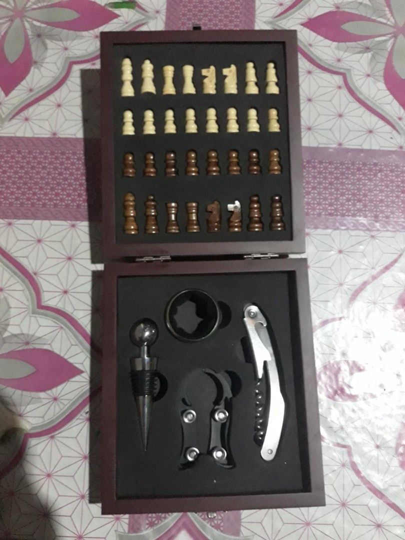 Chess and Wine Set with Wooden Box (Category: Board Games & Puzzles) located in Las Pinas. Submitted by dydythrift74 (Listing ID 1423662395, Image 1). Description: - Chessboard included - Chess pieces in two colors - Wine accessories: bottle stopper, wine opener, and more - Comes in a wooden box - Box features a clasp.