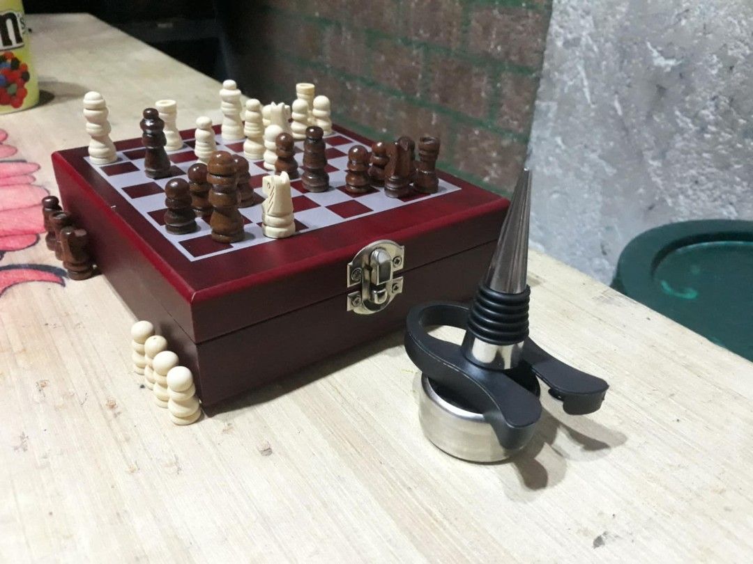 Chess and Wine Set with Wooden Box (Category: Board Games & Puzzles) located in Las Pinas. Submitted by dydythrift74 (Listing ID 1423662395, Image 2). Description: - Chessboard included - Chess pieces in two colors - Wine accessories: bottle stopper, wine opener, and more - Comes in a wooden box - Box features a clasp.