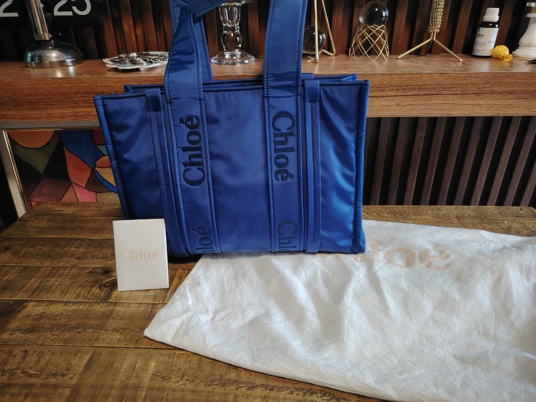 Chloe Woody Tote Bag (Category: Luxury Bags & Wallets) located in Imus. Submitted by angelworks (Listing ID 1423676450, Image 1). Description: - Authentic Chloe Woody tote bag in NYKIN - Vibrant blue color - Chloe logo embroidered on handles - Includes interior pocket - Comes with dust bag and Chloe card - Digital ID tag inside - Perfect for everyday use -LIKE NEW.