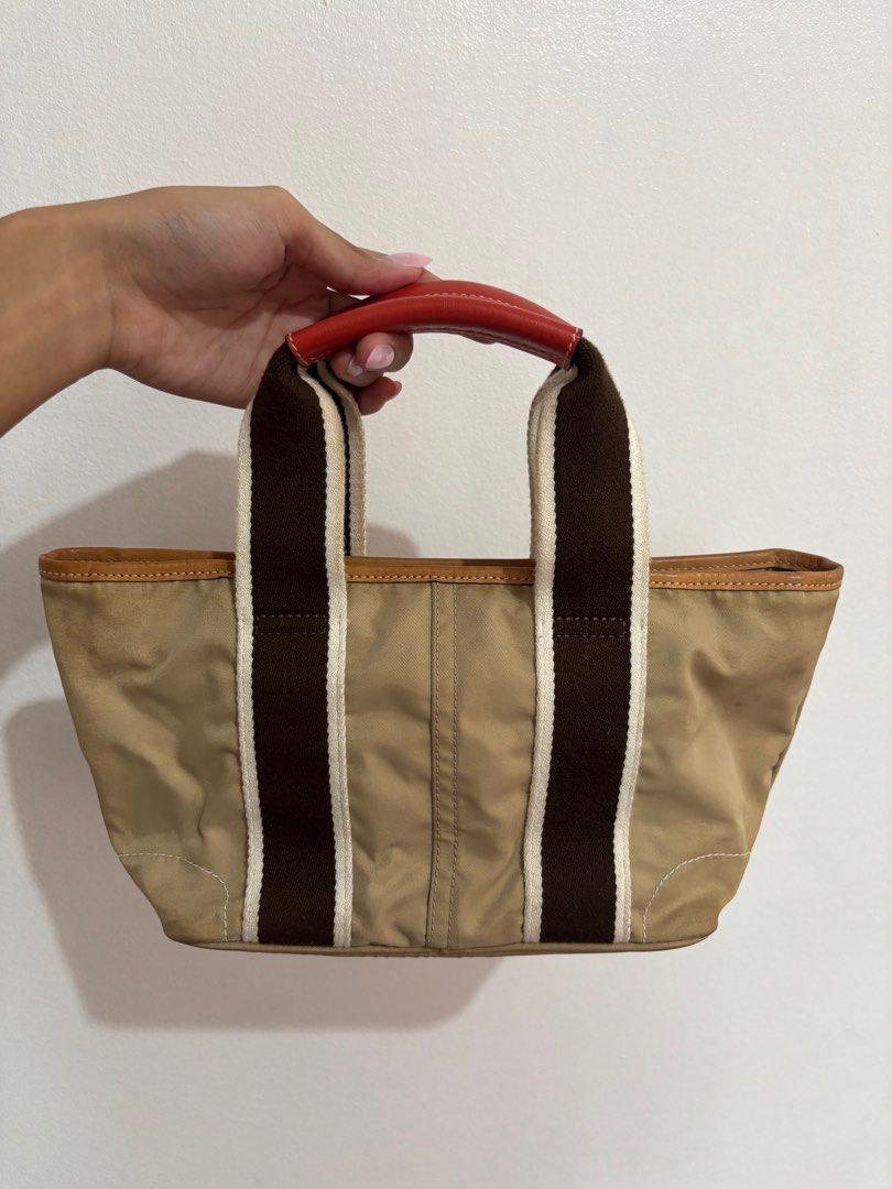 Coach Hampton Mini Weekender Tote Bag (Category: Luxury Bags & Wallets) located in Paranaque City. Submitted by backburnt (Listing ID 1423650219, Image 2). Description: Coach Hampton Mini Weekender Tote Bag (beige/red) - original vintage coach bag, released 2005 - negotiable! - nylon lining - with inner zipper pocket - coach hang tag with daisy - needs cleaning - dm for pics/questions!.