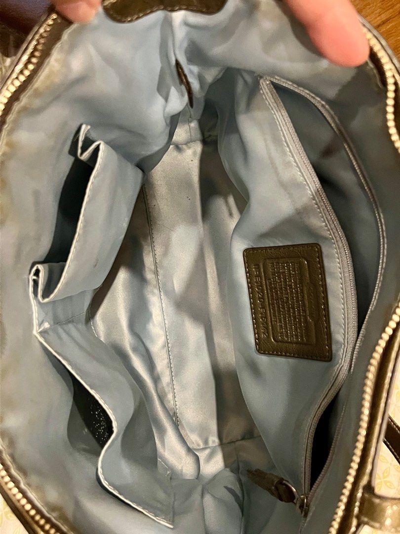 Coach Metallic Tote Bag (Category: Luxury Bags & Wallets) located in Manila. Submitted by gee0505 (Listing ID 1423782393, Image 3). Description: - Coach metallic tote bag - Zip closure - Interior pockets - Coach logo emblem - Light blue fabric lining - Model number: F15142 - Exterior shows staining.