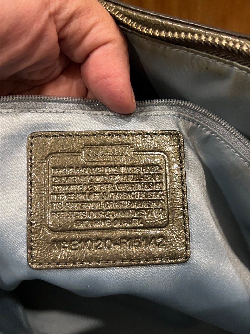 Coach Metallic Tote Bag (Category: Luxury Bags & Wallets) located in Manila. Submitted by gee0505 (Listing ID 1423782393, Image 2). Description: - Coach metallic tote bag - Zip closure - Interior pockets - Coach logo emblem - Light blue fabric lining - Model number: F15142 - Exterior shows staining.