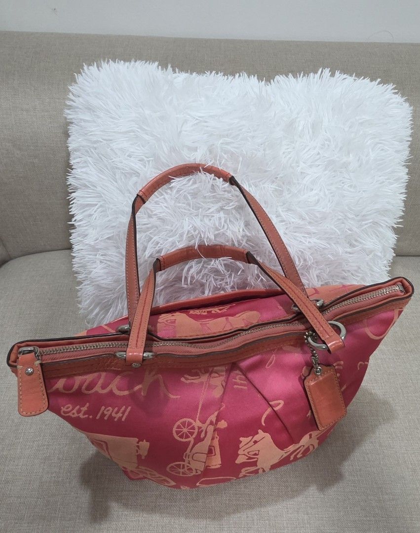 Coach Pink Tote Bag (Category: Luxury Bags & Wallets) located in Dasmarinas. Submitted by m3lbern9s (Listing ID 1423729420, Image 3). Description: - Coach tote bag - Pink color with carriage print - Top zipper closure - Double handles - 100% authentic - Multiple interior pockets - Pink interior lining - Includes a leather tag.