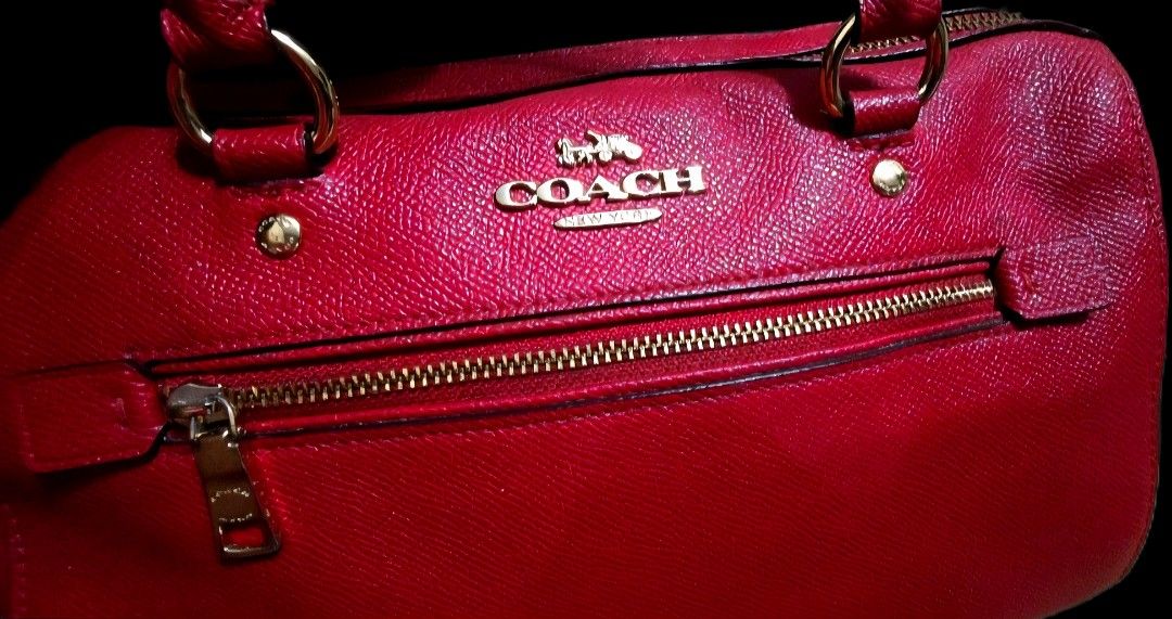 Coach Red Satchel Handbag (Category: Luxury Bags & Wallets) located in Taguig. Submitted by dzkponlineshop (Listing ID 1423675291, Image 2). Description: - Authentic Coach satchel handbag - Color: Red - Features: - Top zipper closure - Front zipper pocket - Dual top handles - Detachable shoulder strap - Gold-toned hardware - Structured shape - Coach logo visible Note: Mini Benette Coach Bag. Thjs is Original gift ng sister ko. Am not using anymor