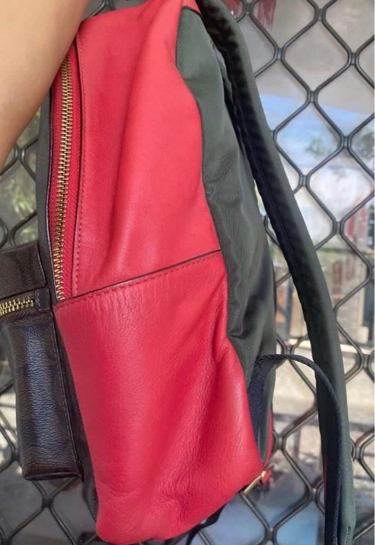 Coach Signature Backpack (Category: Luxury Bags & Wallets) located in Pasig City. Submitted by karenrules (Listing ID 1423617219, Image 3). Description: - Authentic Coach backpack - Signature brown pattern with red accents - Front pocket with gold zipper - Red interior - Gold zippers - Red leather detailing on sides - Interior zippered pocket - Includes Coach tag.