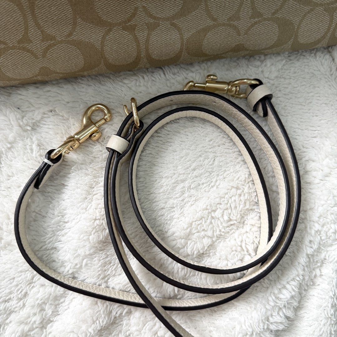 Coach Signature Satchel Handbag (Category: Luxury Bags & Wallets) located in Bulacan. Submitted by klutterbykoko (Listing ID 1423679546, Image 3). Description: - Authentic Coach satchel - Classic Coach signature pattern - Cream-colored accents - Detachable shoulder strap - Top handle - Spacious interior with multiple compartments - Gold-tone hardware - Coach hangtag - Light brown fabric lining.