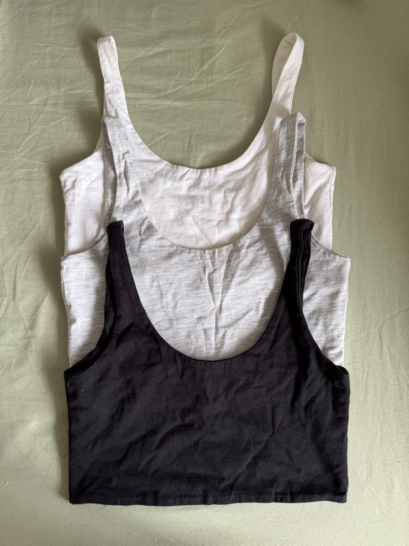 Cotton On Tank Tops Bra (Category: Sleeveless) located in Imus. Submitted by kivecart (Listing ID 1423674784, Image 1). Description: SOLD AS SET - Set of 3 Cotton On tank tops (XS size) - Colors: White (minor stains), black, and grey - Design: Scoop neck - Made in Bangladesh Loc: Imus Cavite MOP: Gcash/BPI MOD: Lalamove/J&T .