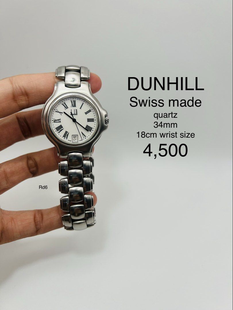 Dunhill Swiss Made Quartz Watch (Category: Luxury Watches) located in Davao. Submitted by timepiece_davao (Listing ID 1423670751, Image 1). Description: Dunhill Swiss Made quartz watch. Features a white dial with Roman numeral hour markers and a date display at the 6 o'clock position. The watch has a 34mm case size and is suitable for a 18cm wrist. The watch is water resistant. The watch is made in Switzerland..