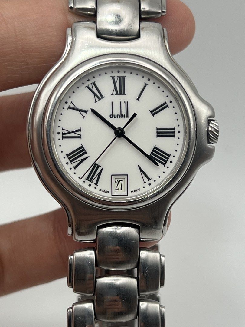 Dunhill Swiss Made Quartz Watch (Category: Luxury Watches) located in Davao. Submitted by timepiece_davao (Listing ID 1423670751, Image 3). Description: Dunhill Swiss Made quartz watch. Features a white dial with Roman numeral hour markers and a date display at the 6 o'clock position. The watch has a 34mm case size and is suitable for a 18cm wrist. The watch is water resistant. The watch is made in Switzerland..