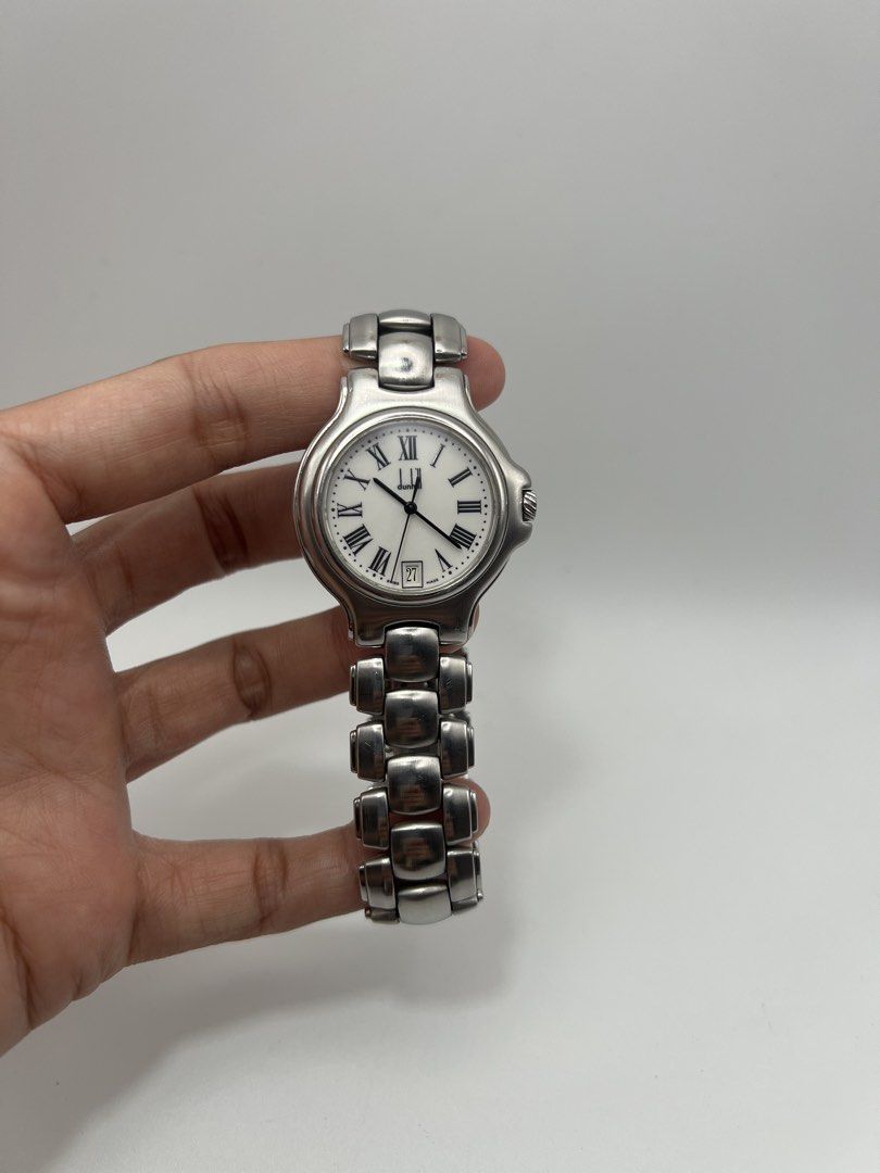 Dunhill Swiss Made Quartz Watch (Category: Luxury Watches) located in Davao. Submitted by timepiece_davao (Listing ID 1423670751, Image 2). Description: Dunhill Swiss Made quartz watch. Features a white dial with Roman numeral hour markers and a date display at the 6 o'clock position. The watch has a 34mm case size and is suitable for a 18cm wrist. The watch is water resistant. The watch is made in Switzerland..