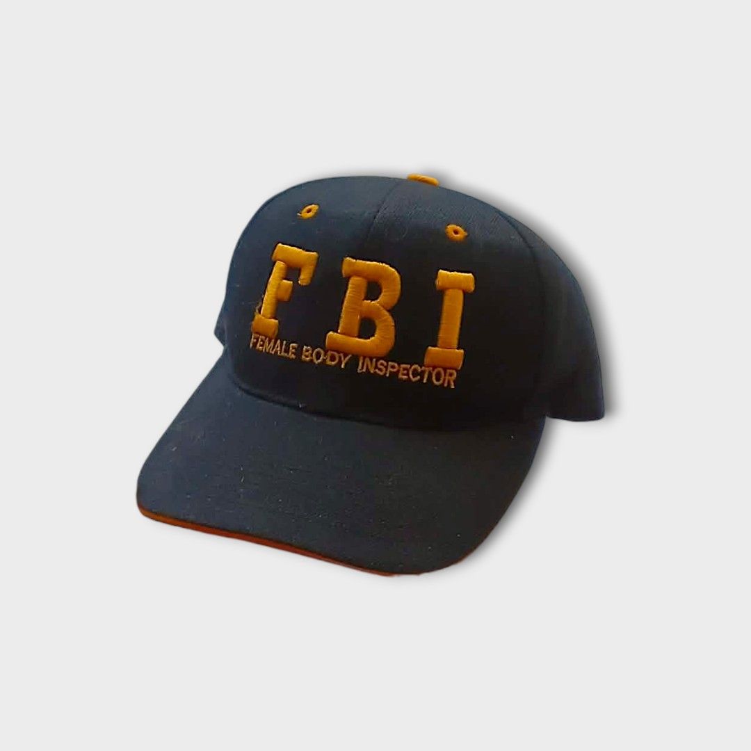 FBI Female Body Inspector Cap (Category: Caps & Hats) located in Gapan. Submitted by head.haven (Listing ID 1423700883, Image 1). Description: - Black cap - Embroidered "FBI" in gold - "Female Body Inspector" text below - Curved brim - Adjustable strap at the back.