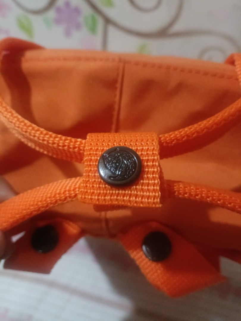 Fjallraven Kanken Classic Backpack - Orange (Category: Backpacks) located in Cebu City. Submitted by dediosmark83726 (Listing ID 1423703676, Image 3). Description: Fjallraven Kanken Classic backpack is in a vibrant orange color. It features the iconic Fjallraven logo on the front and has a classic square design. The backpack includes a front pocket, side pockets, and adjustable straps. The interior has a tag with the Fjallraven logo and informati